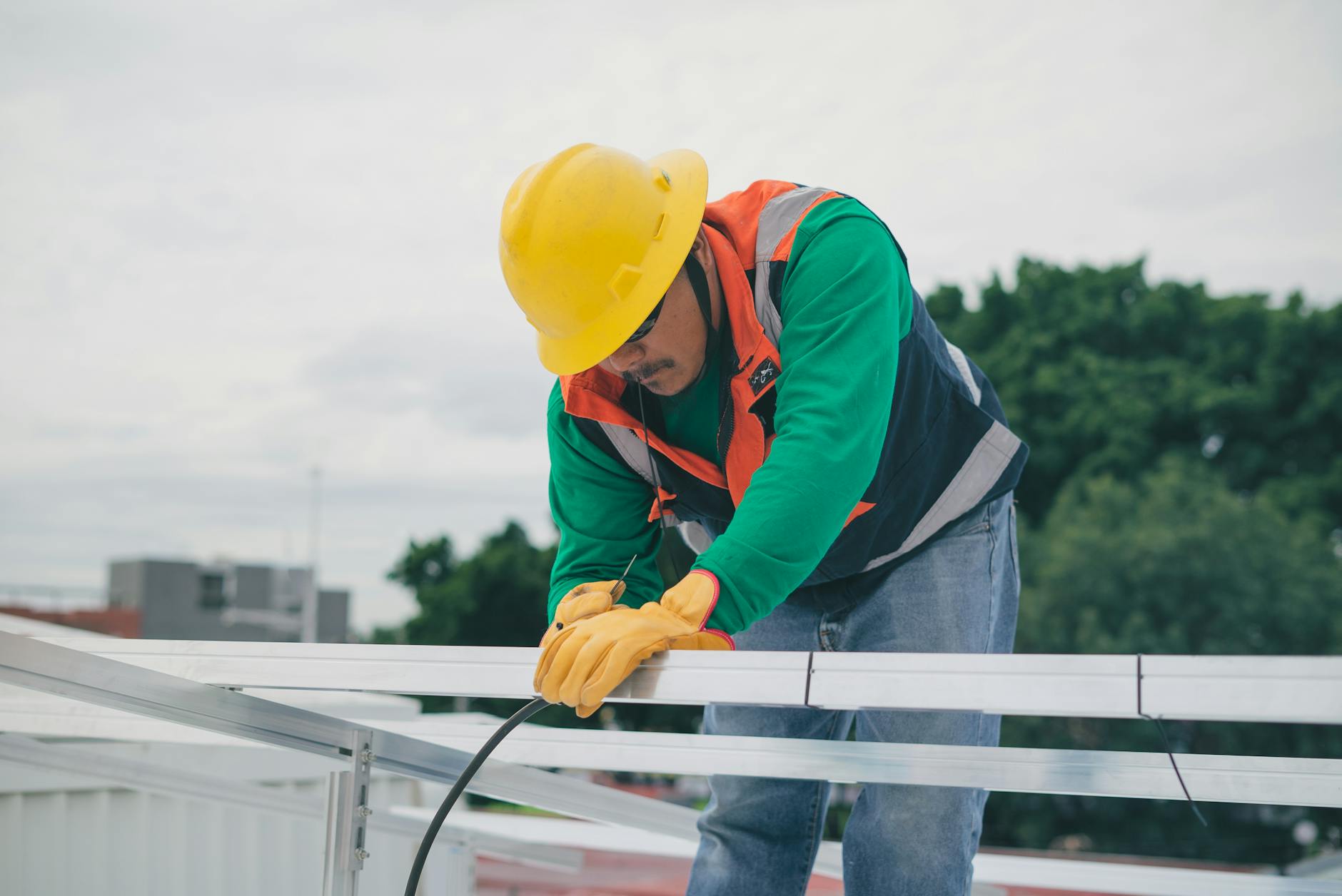 A professional roofing technician inspecting a concrete tile roof on a home in Henderson, Nevada.